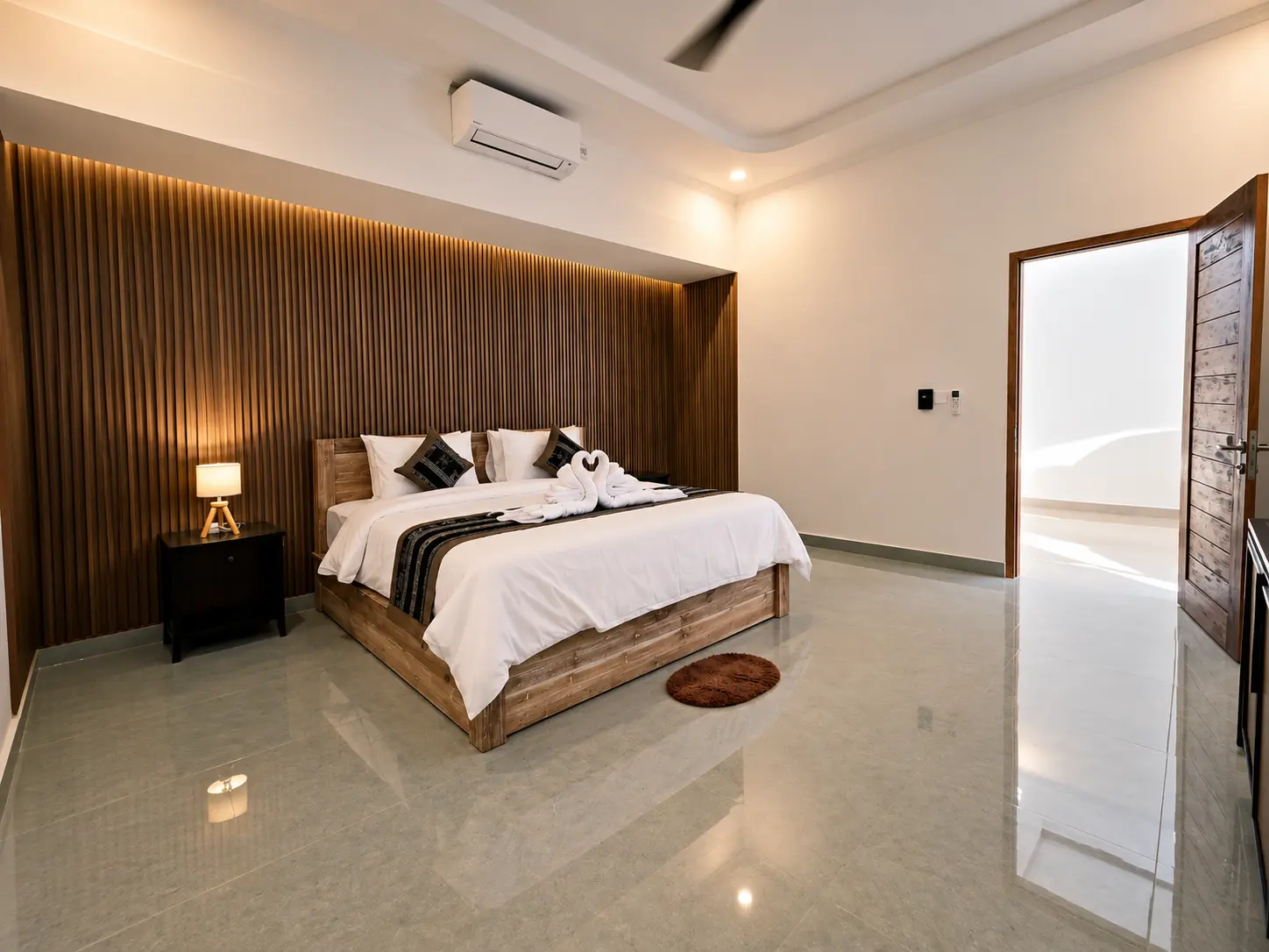 Villa 1 — Bedroom with wooden headboard wall